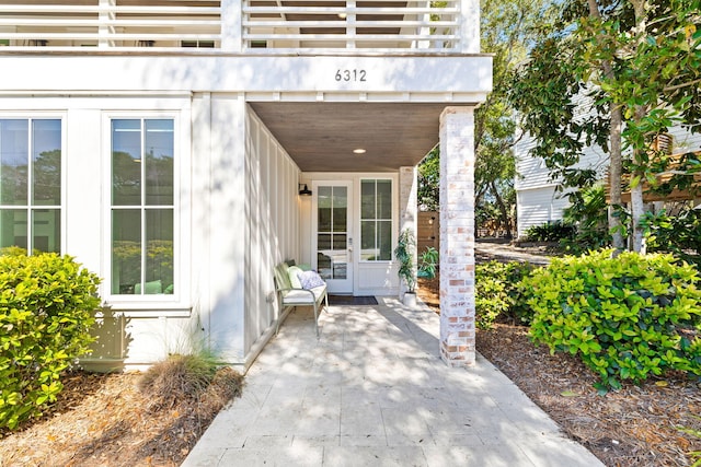 entrance to property with french doors, a patio area, and a balcony