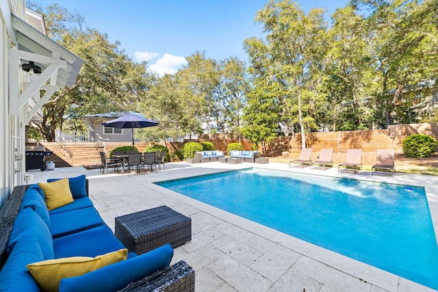 view of swimming pool with a fenced in pool, a patio, a fenced backyard, outdoor lounge area, and outdoor dining space