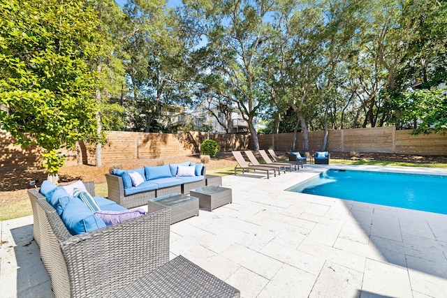 view of swimming pool featuring a fenced in pool, a fenced backyard, a patio, and an outdoor living space