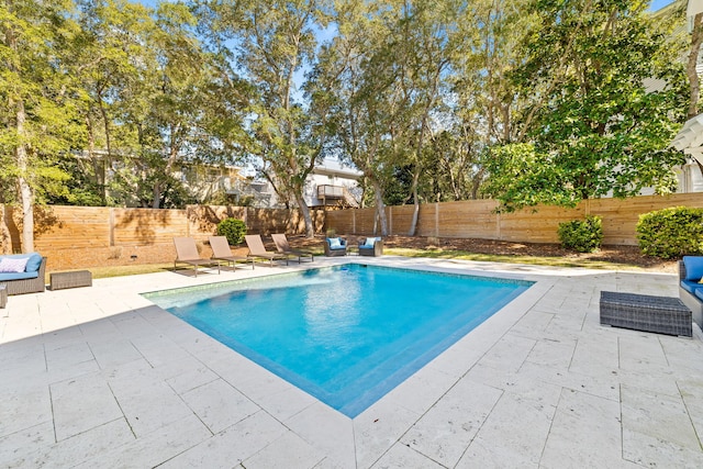 view of swimming pool featuring a patio, a fenced backyard, and a fenced in pool