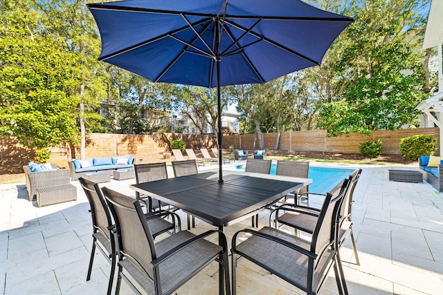 view of patio / terrace with outdoor dining area, a fenced backyard, outdoor lounge area, and a fenced in pool