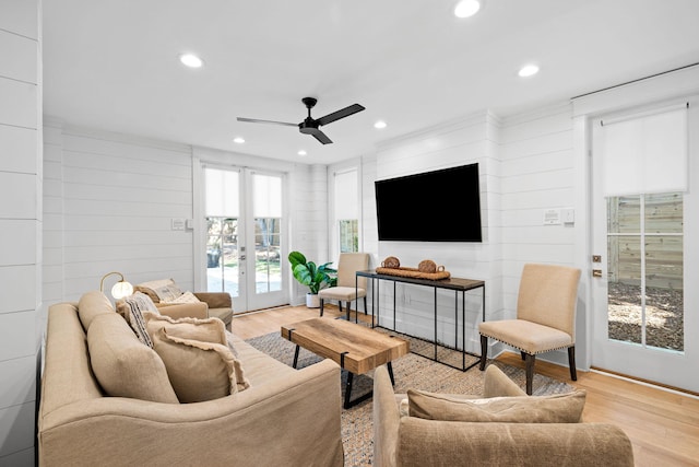 living area with light wood-type flooring, recessed lighting, ceiling fan, and french doors