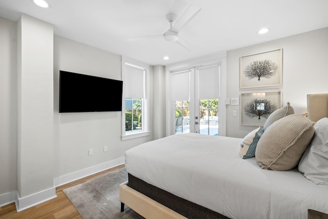 bedroom with access to exterior, recessed lighting, baseboards, and wood finished floors