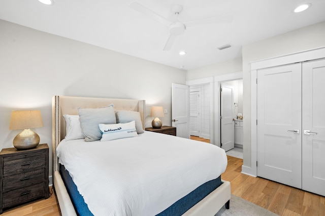 bedroom with light wood-style floors, recessed lighting, a closet, and visible vents