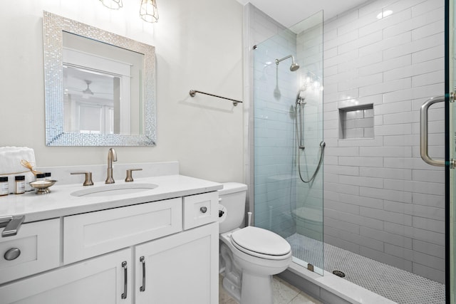 bathroom featuring a stall shower, vanity, and toilet