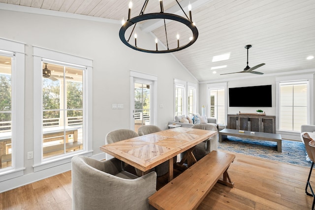 dining space featuring ceiling fan with notable chandelier, high vaulted ceiling, light wood finished floors, and wooden ceiling