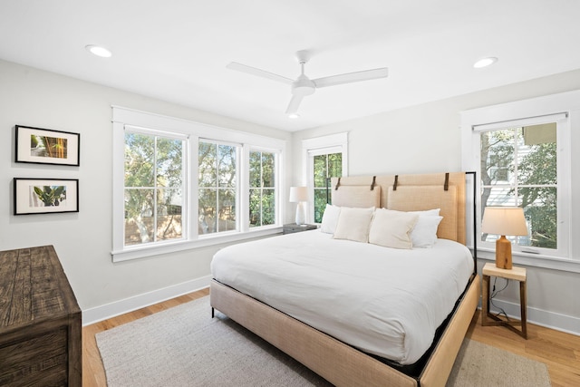 bedroom with light wood-style floors, ceiling fan, baseboards, and recessed lighting