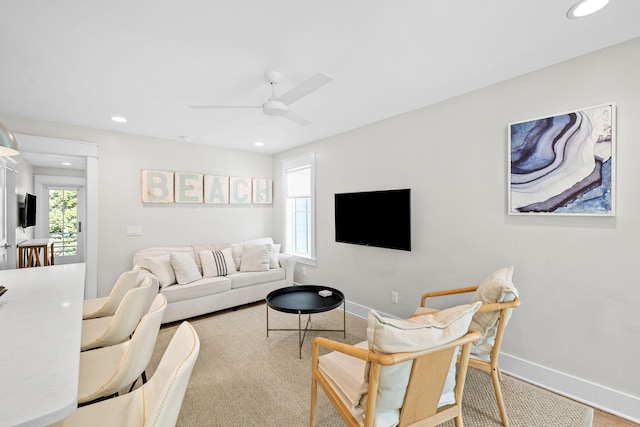 living area featuring ceiling fan, baseboards, and recessed lighting