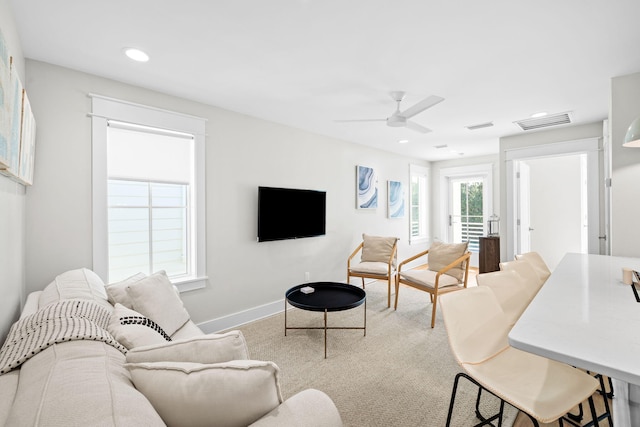 living room featuring baseboards, visible vents, ceiling fan, and recessed lighting