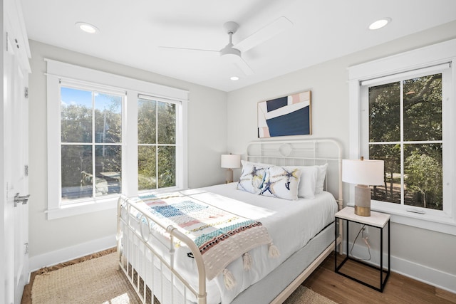 bedroom with recessed lighting, baseboards, and wood finished floors