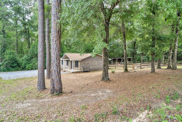 5241 Bob Sikes Rd, Defuniak Springs, FL 32435 - view of yard with covered porch and a view of trees