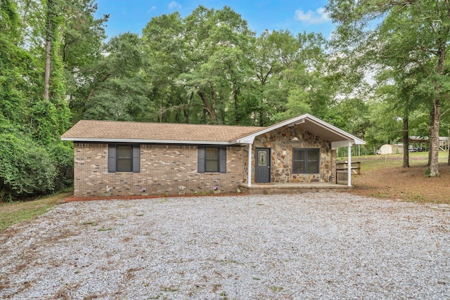 5241 Bob Sikes Rd, Defuniak Springs, FL 32435 - view of front facade with driveway, brick siding, a porch, and stone siding