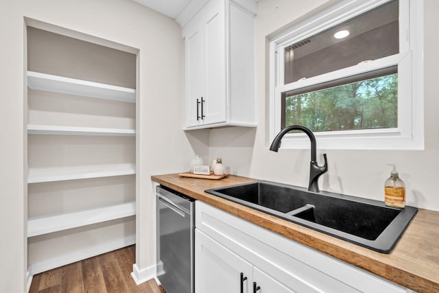 5241 Bob Sikes Rd, Defuniak Springs, FL 32435 - kitchen with a sink, stainless steel dishwasher, white cabinetry, and wood counters