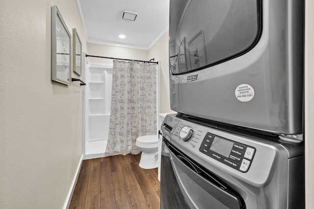 5241 Bob Sikes Rd, Defuniak Springs, FL 32435 - full bath featuring stacked washer and clothes dryer, toilet, crown molding, and wood finished floors