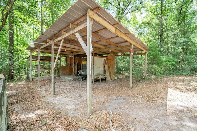 5241 Bob Sikes Rd, Defuniak Springs, FL 32435 - view of patio featuring an outbuilding and a forest view