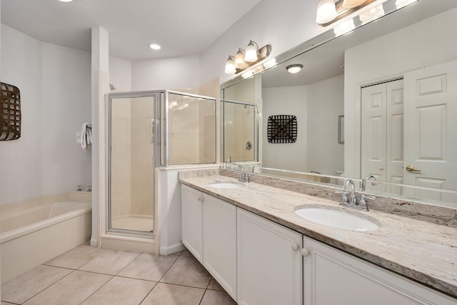 full bathroom with tile patterned flooring, a sink, and a shower stall