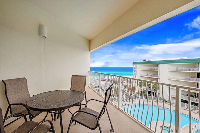 balcony featuring a water view and a beach view