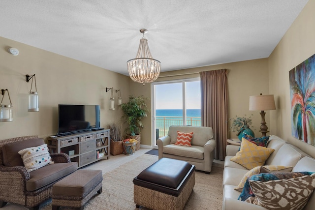 living area featuring light colored carpet and a notable chandelier