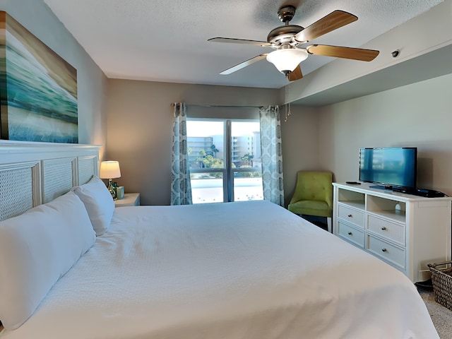 bedroom featuring ceiling fan and a textured ceiling