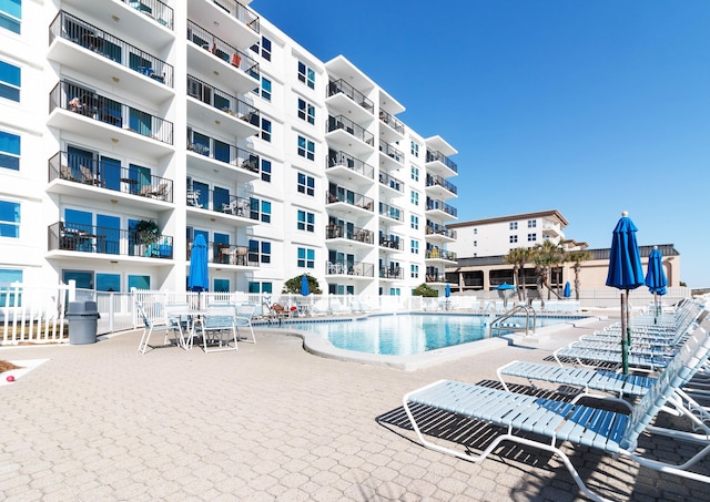 pool featuring a patio area and fence