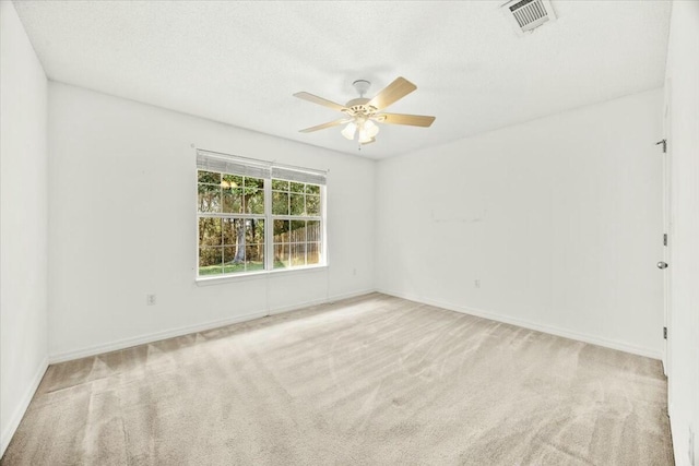 empty room featuring baseboards, carpet, visible vents, and a ceiling fan