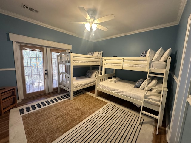 bedroom with access to outside, crown molding, visible vents, and wood finished floors