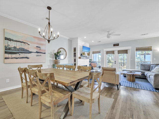 dining space featuring french doors, crown molding, recessed lighting, wood finished floors, and baseboards