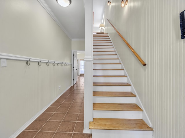 stairs featuring tile patterned flooring and crown molding