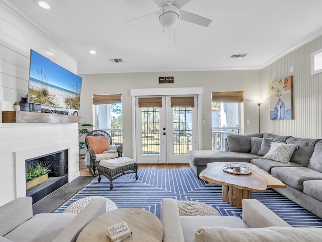 living room featuring french doors, visible vents, and a healthy amount of sunlight