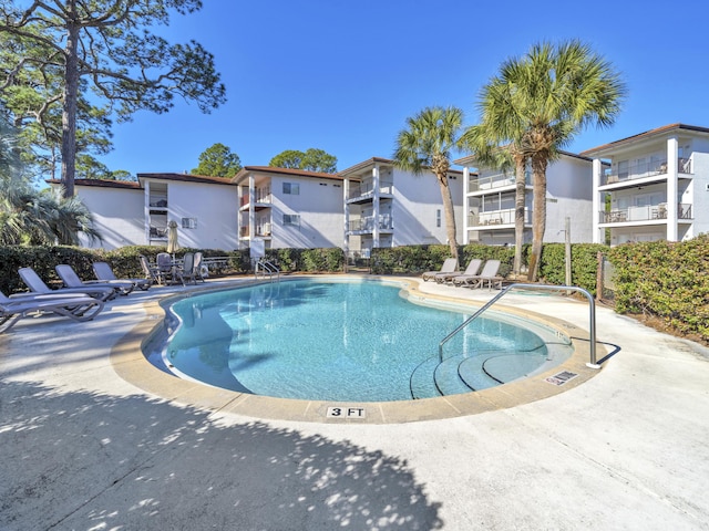 pool featuring a patio and fence