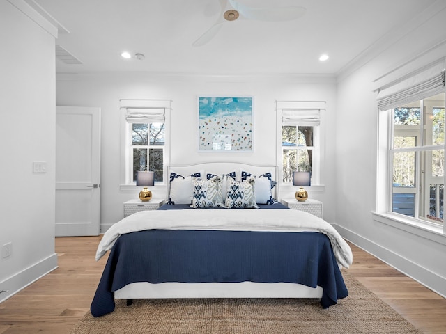 bedroom featuring recessed lighting, baseboards, multiple windows, and light wood finished floors