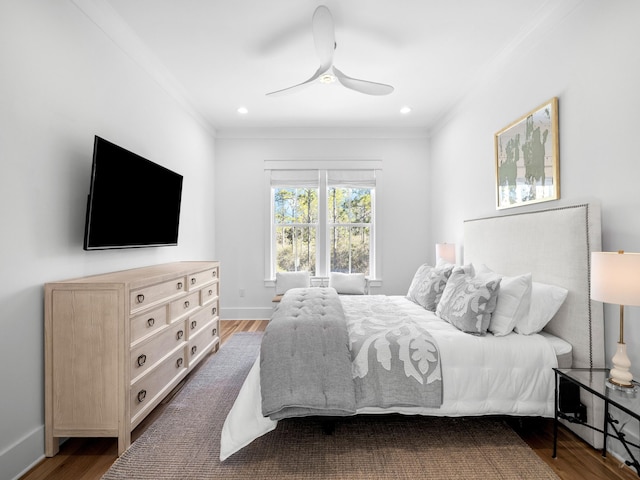 bedroom featuring recessed lighting, ornamental molding, baseboards, and wood finished floors