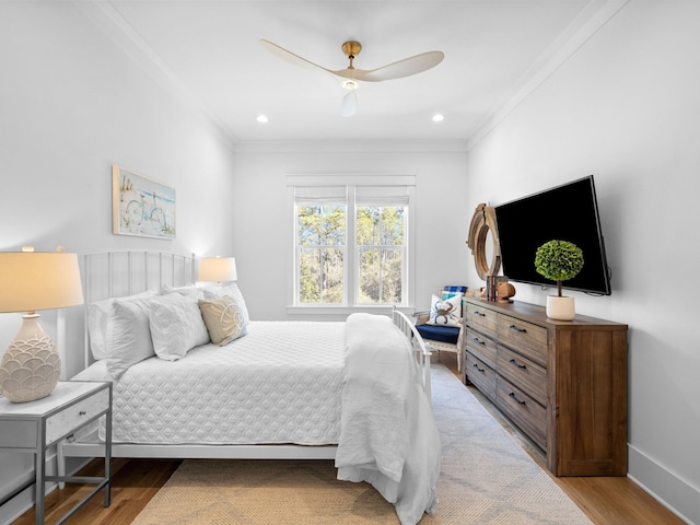 bedroom featuring recessed lighting, baseboards, wood finished floors, and crown molding