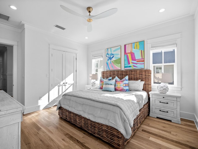 bedroom with recessed lighting, visible vents, ornamental molding, and light wood finished floors