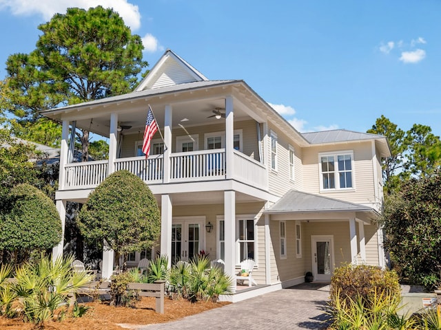 view of front facade with french doors, a balcony, metal roof, and a ceiling fan