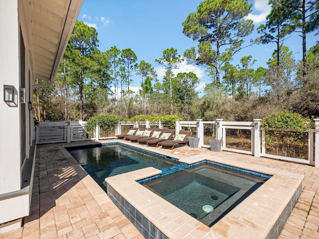 view of swimming pool with an in ground hot tub and a patio area