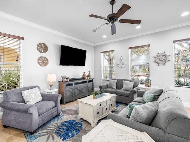 living area featuring ornamental molding, recessed lighting, and a healthy amount of sunlight