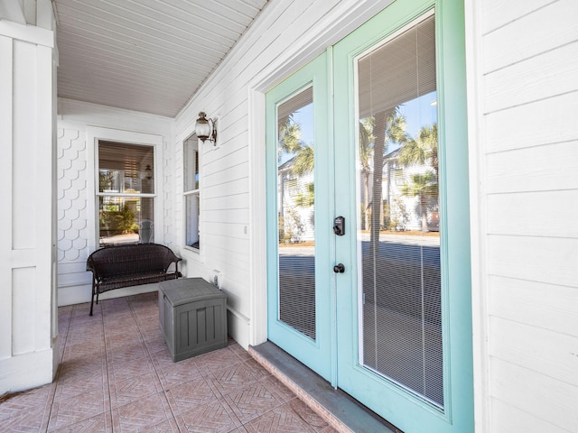 entrance to property featuring covered porch and french doors