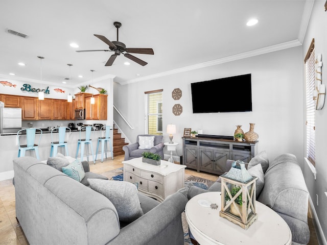 living room with visible vents, crown molding, and recessed lighting