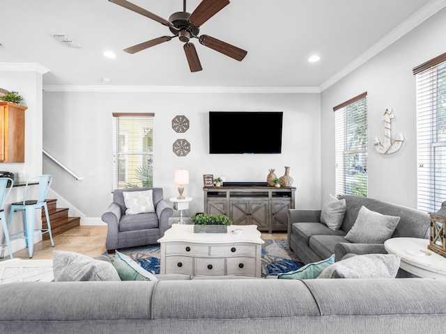 living room featuring baseboards, stairway, visible vents, and crown molding