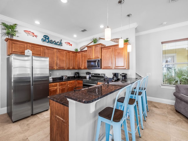 kitchen featuring crown molding, a peninsula, appliances with stainless steel finishes, and brown cabinets