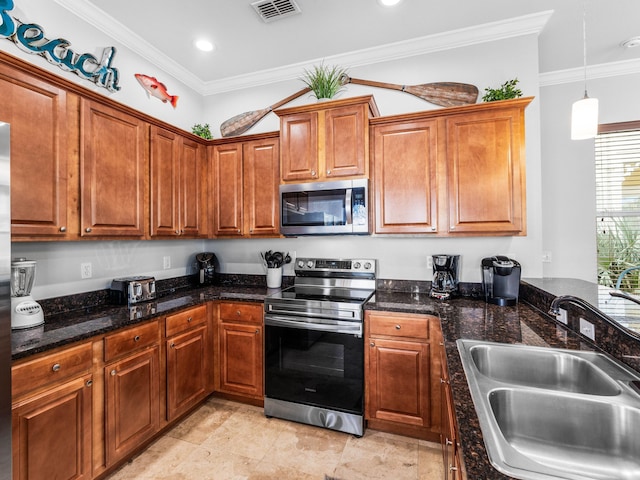 kitchen with brown cabinets, stainless steel appliances, visible vents, ornamental molding, and a sink