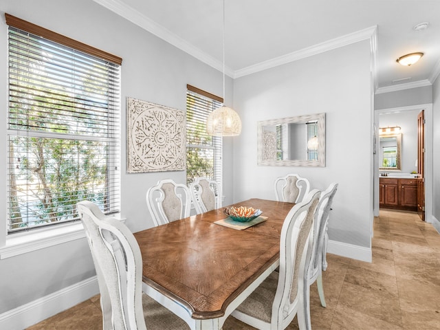 dining room featuring ornamental molding and baseboards