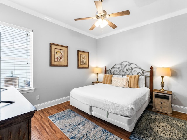 bedroom featuring ornamental molding, wood finished floors, a ceiling fan, and baseboards