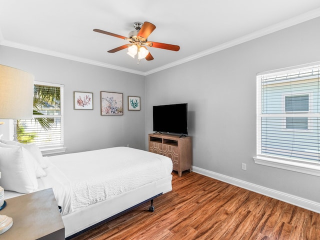 bedroom with ornamental molding, ceiling fan, baseboards, and wood finished floors