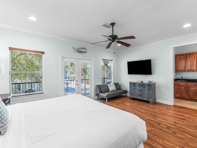 bedroom featuring visible vents, wood finished floors, access to outside, crown molding, and french doors