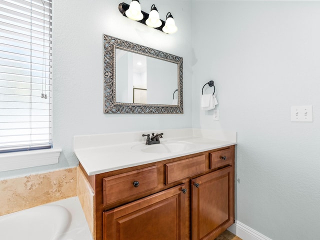 bathroom featuring a garden tub and vanity