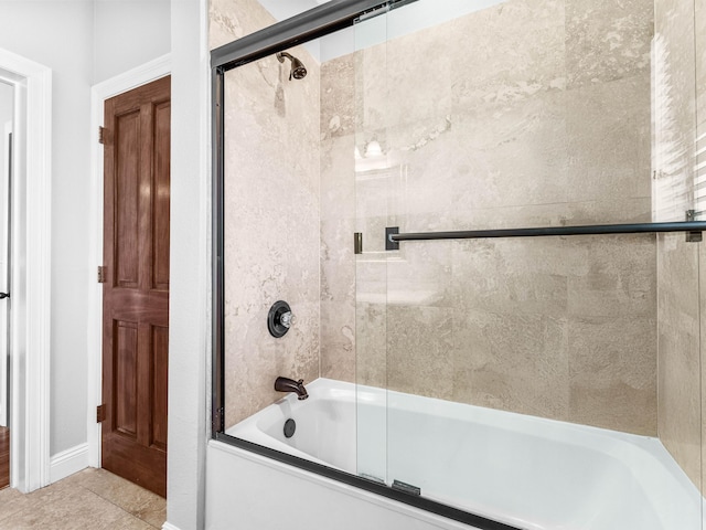 bathroom featuring tile patterned floors and bath / shower combo with glass door