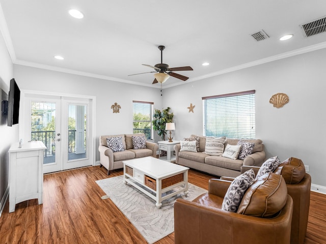 living room featuring french doors, wood finished floors, visible vents, and crown molding