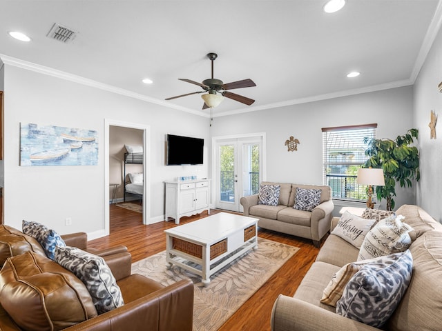 living area featuring recessed lighting, wood finished floors, visible vents, and crown molding